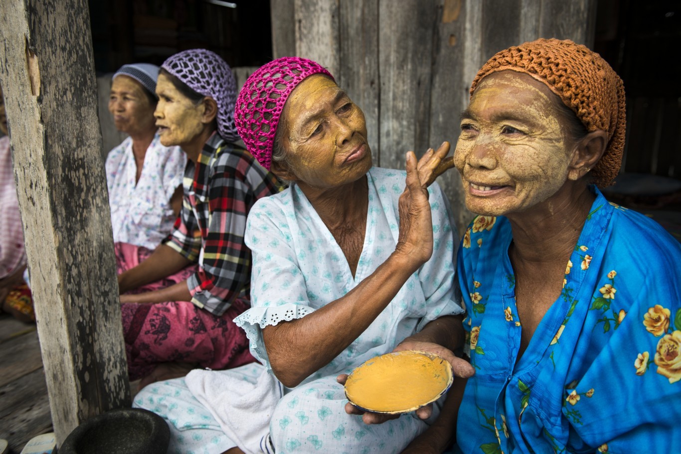 Sama-Bajau women applying a natural paste on their faces